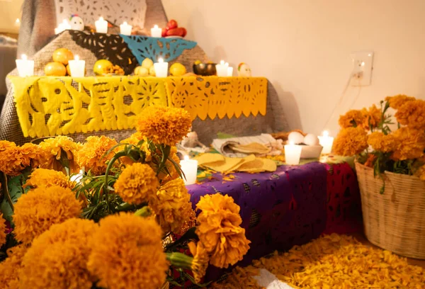 stock image A Day of the Dead altar with cempasuchil flowers, papel picado, fruit and candles