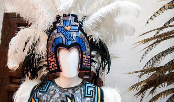 A Aztec Mexican dancer headdress with exotic bird feathers and traditional sewing decorations
