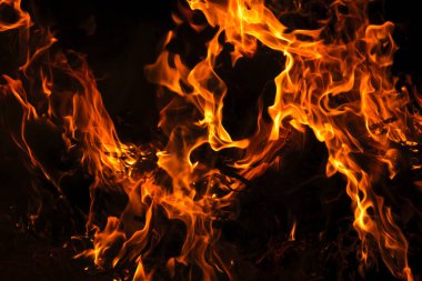 A Intense fire with black background, with space for text clipart