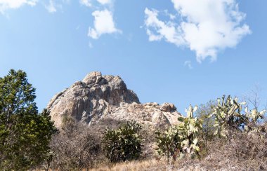 A Bernal Peak, Monolith in Queretaro, Mexico, with a blue sky. clipart