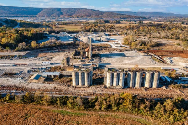 Processing plant for crushed stone, lime and gravel. Mining and quarry mining equipment. Gravel quarry and stone crushing and screening plant with the mountains and fall foliage in the background. This facility in in Cowan, Tennessee U.S.A.