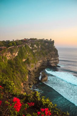 Waves of Indian ocean near cliffs. Uluwatu, Bali, Indonesia. Sunset on the sea. High quality photo