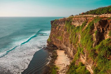 Sunset on the ocean coast, Uluwatu beach, Bali, Indonesia. Waves and cliffs in Uluwatu. High quality photo