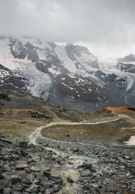 Railway and train in cloudy Gornergrat mountains. Zermatt, Swiss Alps. Adventure in Switzerland. High quality photo