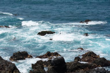 Rocks in the breakers on the coast of the Canary Island of Tenerife, Spain