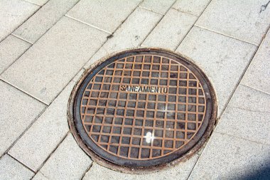 Manhole cover in a sidewalk