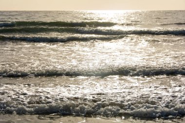 Gün doğumunda gökyüzü ile denizde dalgalar