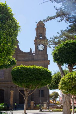 Trees overlooking the church of Santiago de los Caballeros in the town of Galdar on the Canary Island of Gran Canaria, Europe clipart