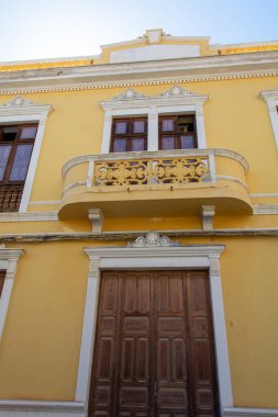 Old yellow house with a balcony in the Spanish town of Galdar on Gran Canaria clipart