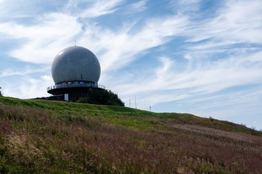 Radar kubbesi, Almanya 'nın yüksek Rhoen bölgesindeki Wasserkuppe zirvesinde, yeşil bir çayır ve pembe bir Willonerb ile, mavi gökyüzü ile güzel bir yaz günü