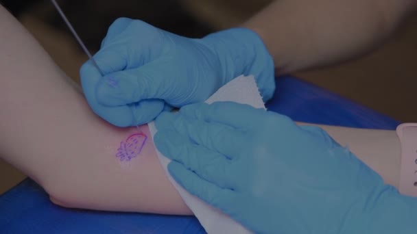 Närbild Professionell Tatuerad Kvinna Som Tatuerar Sig Ung Flickas Ben — Stockvideo