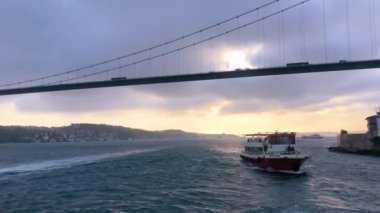The ferry sails along the Bosphorus against the backdrop of the Bosphorus Bridge. Ferry in the Bosphorus.