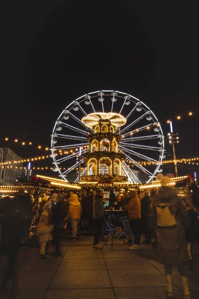 stock image 3.12. 2022 - Katowice, Poland. Christmas decorations at the Christmas market during Advent on the main square Rynek, Katowice. Refreshment stand, people and ferris wheel.