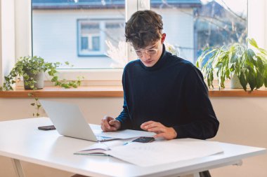 Brown-haired entrepreneur comes to the company with a new working concept, which he calculates with other technological accessories and writes his notes in his laptop.