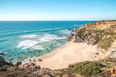 Portekiz 'in Odemira kenti Vila Nova de Milfontes yakınlarındaki Atlantik kıyısındaki Praia da Angra da Cerva kumsalını saran uçurumlar nefes kesicidir. Rota Vicentina 'nın izinden. Balıkçı patikası.