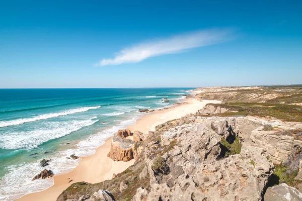 stock image Rocks surround the sandy beach of Praia do Malhao Sul on the Atlantic coast near Vila Nova de Milfontes, Odemira, Portugal. In the footsteps of Rota Vicentina. Fisherman trail.