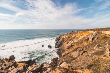 Güneşin saldırısı altındaki kayalıklar yavaş yavaş Portekiz 'in batısındaki Odemira bölgesindeki Atlantik Okyanusu' na dökülüyor. Balıkçı Patikası boyunca gezinen, Rota Vicentina.