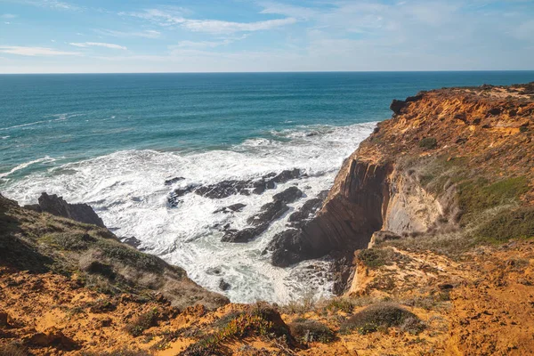 stock image Breathtaking prehistoric cliffs on the Atlantic coast of Odemira region, western Portugal. Wandering along the Fisherman Trail, Rota Vicentina.