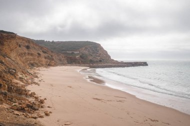 Portekiz 'in güney yarımadasının dağlık kıyı şeridi Algarve' ın ünlü turistik bölgesinde. Luz kasabasının etrafındaki kayalık kayalıklar. Balıkçı patikasını keşfeden, Rota Vicentina.