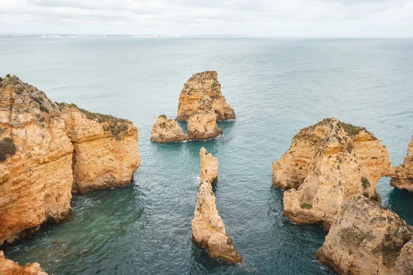 stock image Famous tourist destination of Ponta da Piedade on the southern peninsula of Lagos in the Algarve region of Portugal. Cape of yellow-gold cliffs during the afternoon.