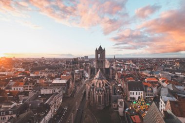 Şehrin merkezindeki tarihi kuleden Ghent 'te gün batımını izliyordum. Gökyüzünde romantik renkler. Gent 'i aydınlatan kırmızı ışık, Flanders bölgesi, Belçika.