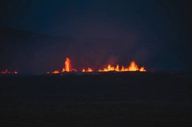 Fagradalsfjall area under volcanic activity. Grindavik Iceland. Bright volcanic eruptions light up the dark Icelandic night, with glowing lava fountains piercing the shadows. clipart