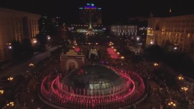 Independence Square. Kiev Kyiv. Ukraine. Aerial view of the fountains. Evening. People walk around the square. Building. On the road there are cars. Singing Fountains