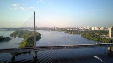 Kiev şehrinin güney köprüsünün hava fotoğrafları. Ukrayna. Dinyeper nehri, köprü nehri geçer. Geceleri nehir köprüsünün havadan görünüşü köprüdeki araba ve trenlerin hareketleri..