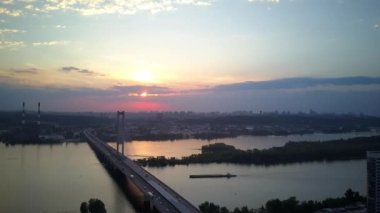 Aerial photography of the south bridge, Kiev city. Ukraine. Dnieper river, the bridge crosses the river. Cityscape aerial view of a river bridge at night The movement of cars and trains on the bridge.