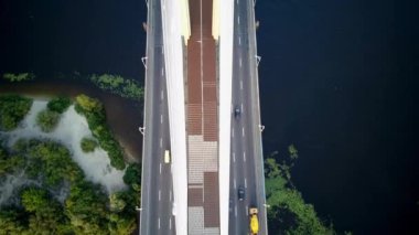 Aerial photography of the south bridge, Kiev city. Ukraine. Dnieper river, the bridge crosses the river. Cityscape aerial view of a river bridge at night The movement of cars and trains on the bridge.