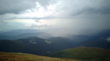 4K .Aerial beautiful l landscape . Smooth fly over mountains clouds ,ridges and hills. Blue sky over the mountains. Flying through the clouds and above the mountains, epic natural landscape .