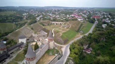 Aerial, top view from Drone. The fortress located among the picturesque nature in the historic city of Kamianets-Podilskyi, Ukraine. Old fortress. Stone castle. Medieval castle