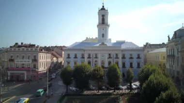 Sunny aerial view on Chernivtsi - old western Ukrainian city. Aerial top view of the city centre, surrounded by picturesque houses with red roofs,streets,road.