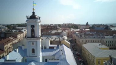 Sunny aerial view on Chernivtsi - old western Ukrainian city. Aerial top view of the city centre, surrounded by picturesque houses with red roofs,streets,road.