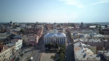 Sunny aerial view on Chernivtsi - old western Ukrainian city. Aerial top view of the city centre, surrounded by picturesque houses with red roofs,streets,road.
