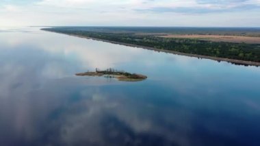 aerial from above cloudy day. Fly towards big beautiful lake and little picturesque town at top view video, erial shot of the artificial lake , Cinematic aerial of Lake, Sunset on the big lake 