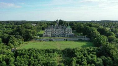 Old castle Podgortsy, Ukraine. View of the castle from above, aerial view from a drone. Podgoretsky castle. On the horizon is an old church. Architectural structure of medieval forest on a hill