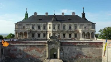 Old castle Podgortsy, Ukraine. View of the castle from above, aerial view from a drone. Podgoretsky castle. On the horizon is an old church. Architectural structure of medieval forest on a hill