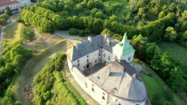 Olesko Palace from the air. Reserve. Summer park on the hills. Ukraine. Aerial shot Village Olesk castle. Ukraine. Aerial view of the Olesky Castle and residential neighborhoods near it