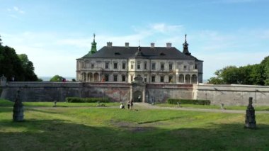 Old castle Podgortsy, Ukraine. View of the castle from above, aerial view from a drone. Podgoretsky castle. On the horizon is an old church. Architectural structure of medieval forest on a hill