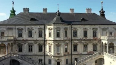 Old castle Podgortsy, Ukraine. View of the castle from above, aerial view from a drone. Podgoretsky castle. On the horizon is an old church. Architectural structure of medieval forest on a hill