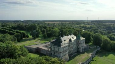 Old castle Podgortsy, Ukraine. View of the castle from above, aerial view from a drone. Podgoretsky castle. On the horizon is an old church. Architectural structure of medieval forest on a hill