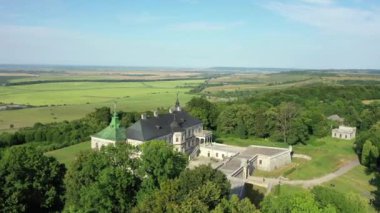 Old castle Podgortsy, Ukraine. View of the castle from above, aerial view from a drone. Podgoretsky castle. On the horizon is an old church. Architectural structure of medieval forest on a hill