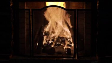 Şömine. Rahatlatıcı Şömine. Yakacak odun. Bir kır evinin alevleri. Sıcaklık ve ev konforu. Toprak. Şöminede ateş yanıyor. Şöminede güzel bir ateş, yanan bir odun. 