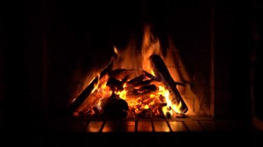 Şömine. Rahatlatıcı Şömine. Yakacak odun. Bir kır evinin alevleri. Sıcaklık ve ev konforu. Toprak. Şöminede ateş yanıyor. Şöminede güzel bir ateş, yanan bir odun. 