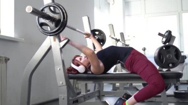 Genç bir kadın spor yapıyor, spor yapıyor, spor yapıyor, spor salonunda spor yapıyor, spor yapıyor, spor yapıyor ve birlikte antrenman yapıyor. Yoğun kas egzersizi yapan kadınlar. 