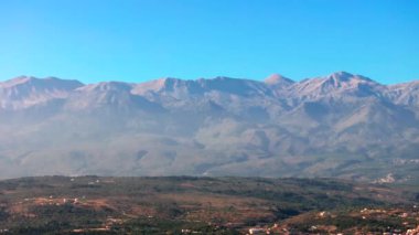 Yunanistan 'daki Girit adasının Dağ Havası manzarası. Gün batımında dağ manzarası, zeytin ağaçları ve üzüm bağları. Güney Ege Denizi üzerinde uçan hava videosu Oia, Santorini, Yunanistan, gün doğumunu gösteriyor