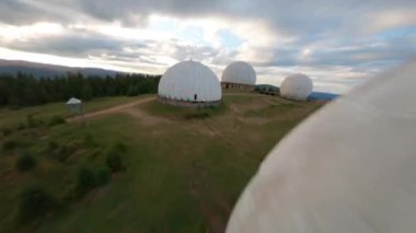 FPV, Karpatlar 'daki terk edilmiş radar istasyonu Pamir, Ukrayna' daki Karpatlar 'daki dağın tepesindeki araştırma istasyonu. Büyük beyaz balonlar, köknar ağaçları arasında dağlarda dizayn edilir.