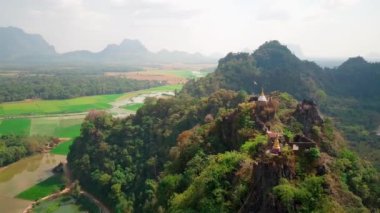 Hava aracı videosu, gün batımında Vietnam 'ın dağları ve pirinç tarlaları. Bereketli yeşil yağmur ormanları şafak vakti sisli dağlarla kaplı Karst Dağları Kedi Ba Adası, Halong Körfezi, Vietnam