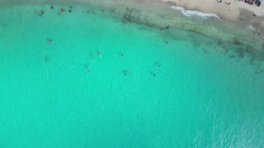 Aerial drone footage over Playa Porto Marie in West Punt Curaca. Carribean beach drop down footage over the clear sea and sand. High quality 4k footage